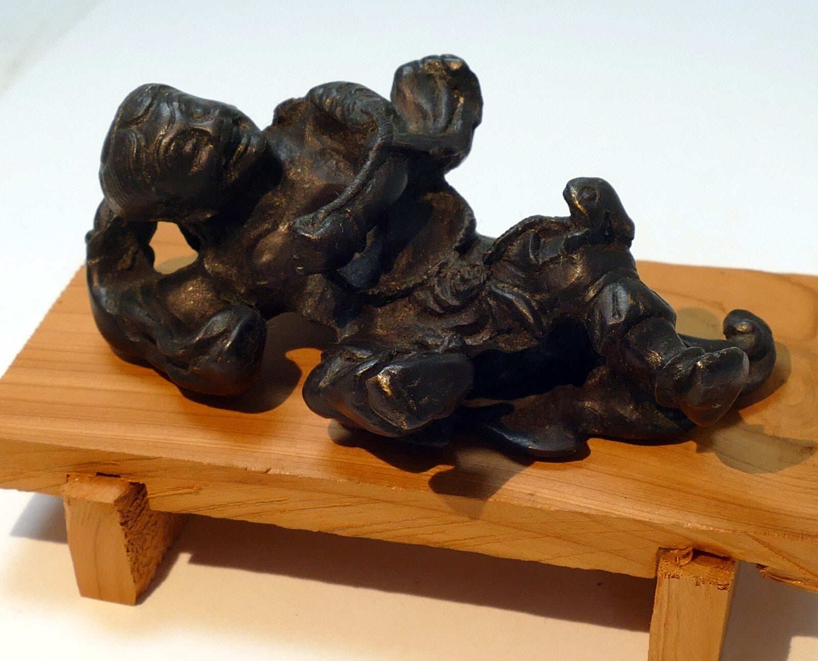 Bronze statue reclining individual scroll weight immortal