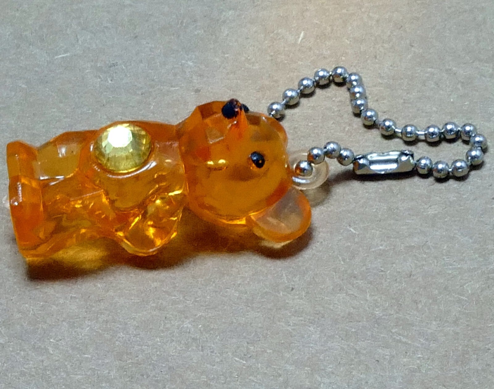 Hard plastic pink bear yellow/gold jewel on belly keychain 2"